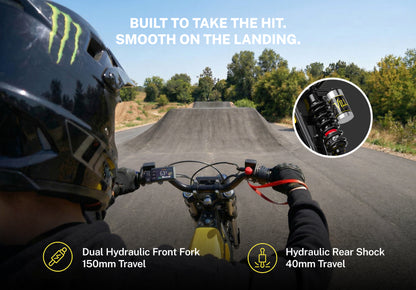 Heybike V1 electric dirt bike with 150mm dual hydraulic front fork and 40mm rear shock on a dirt jump track.